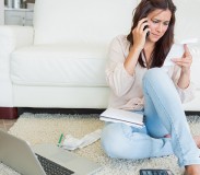 Woman calling and reading a bill