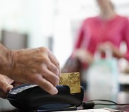 Shopkeeper Using Credit Card Machine